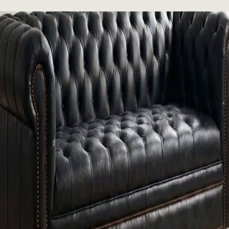 Black top-grain buffalo leather on a hand-tufted Chesterfield