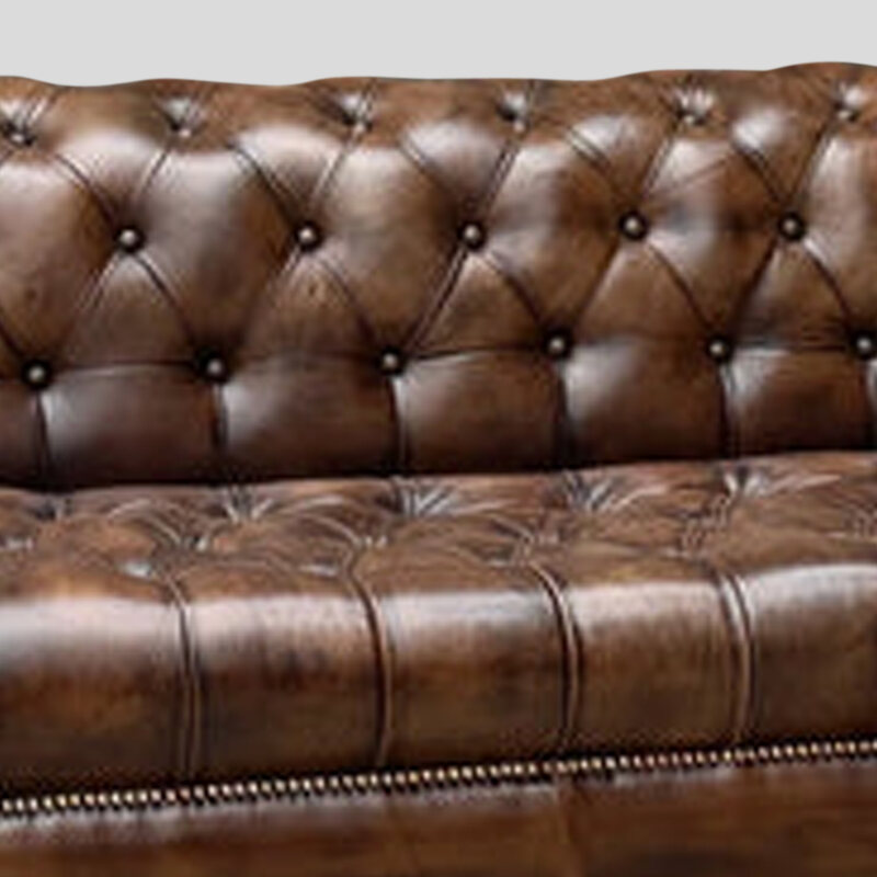 Aged Tan top-grain buffalo leather on a hand-tufted Chesterfield